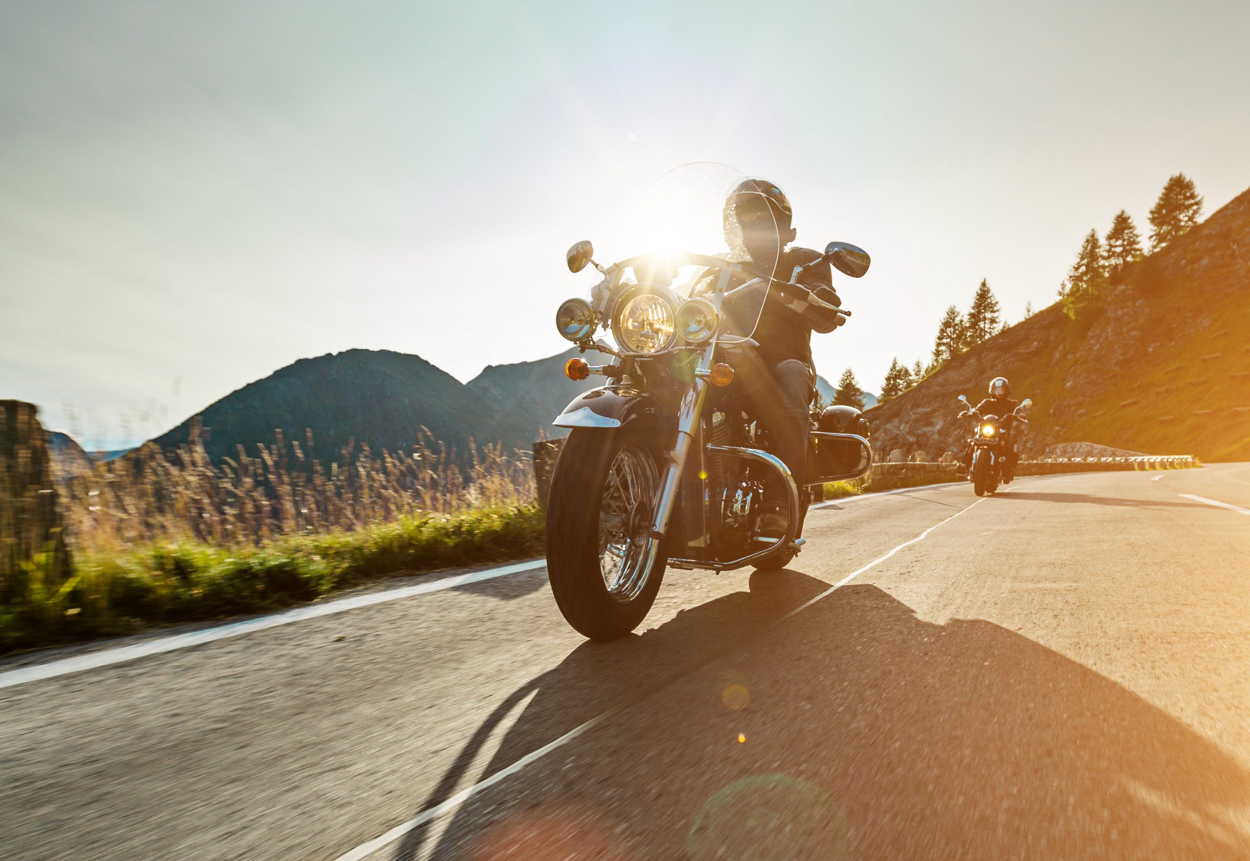 Motorcycle drivers riding in Alpine highway on famous Hochalpenstrasse, Austria, central Europe.